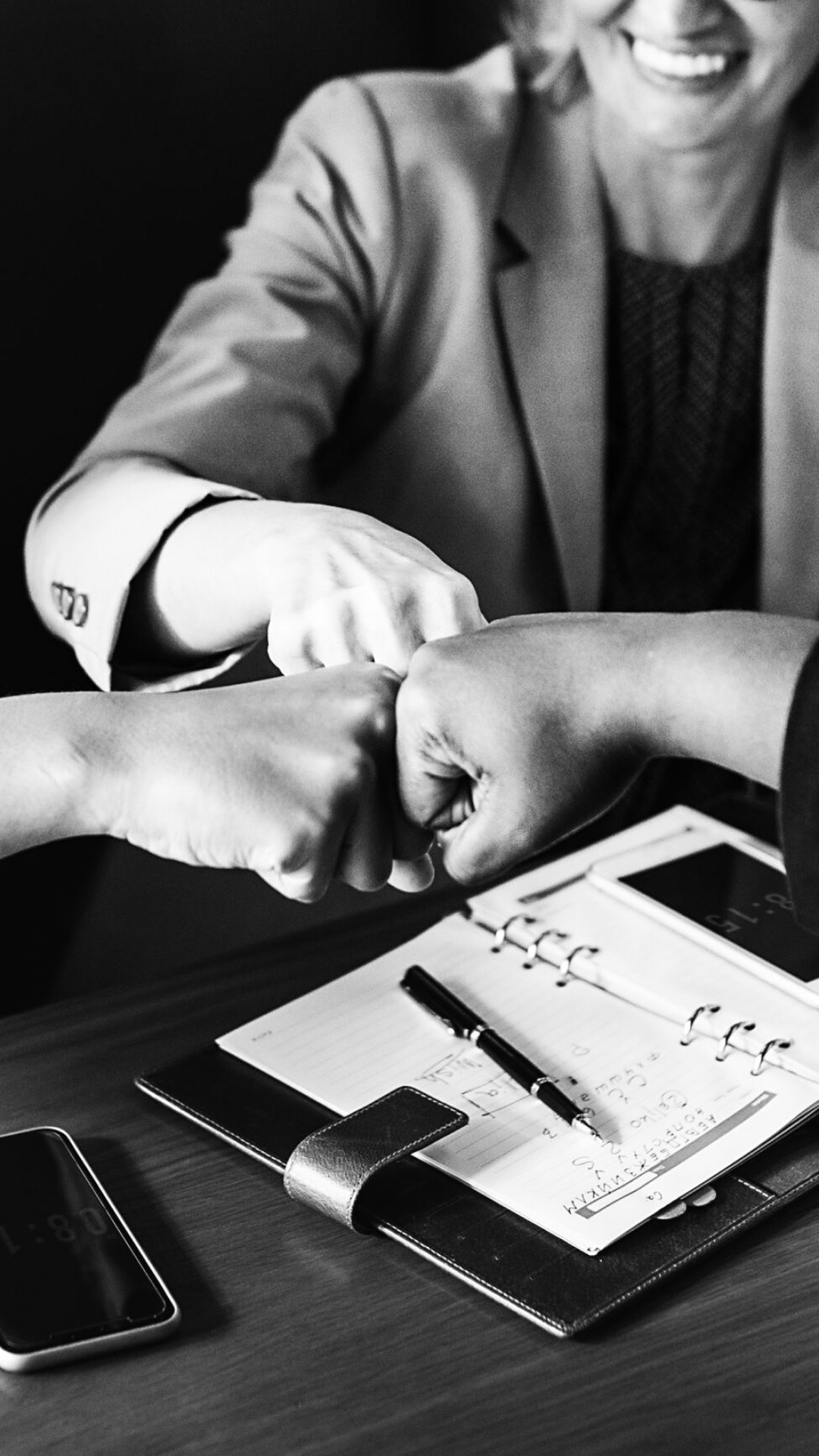 Businesswomen in a fist bump